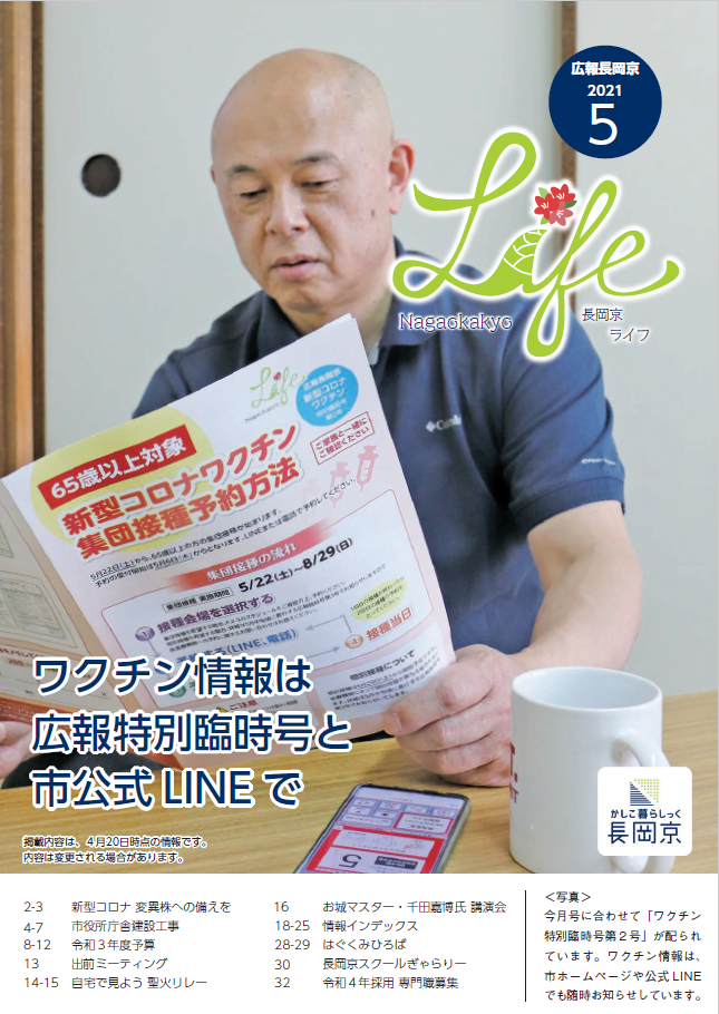 長岡京ライフ2021年5月号の表紙。臨時号を読んでいる人の写真。